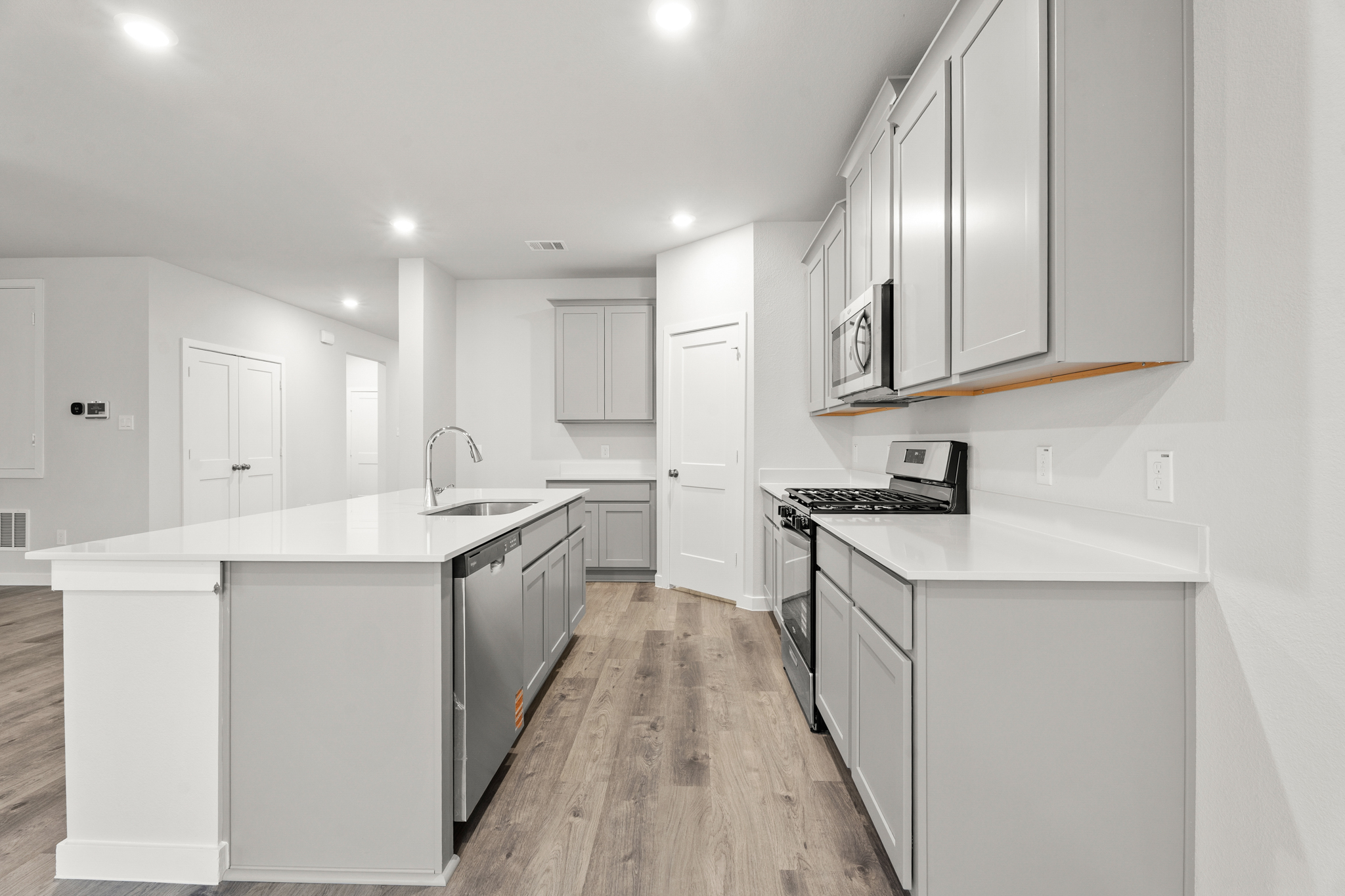 A kitchen with white cabinets.