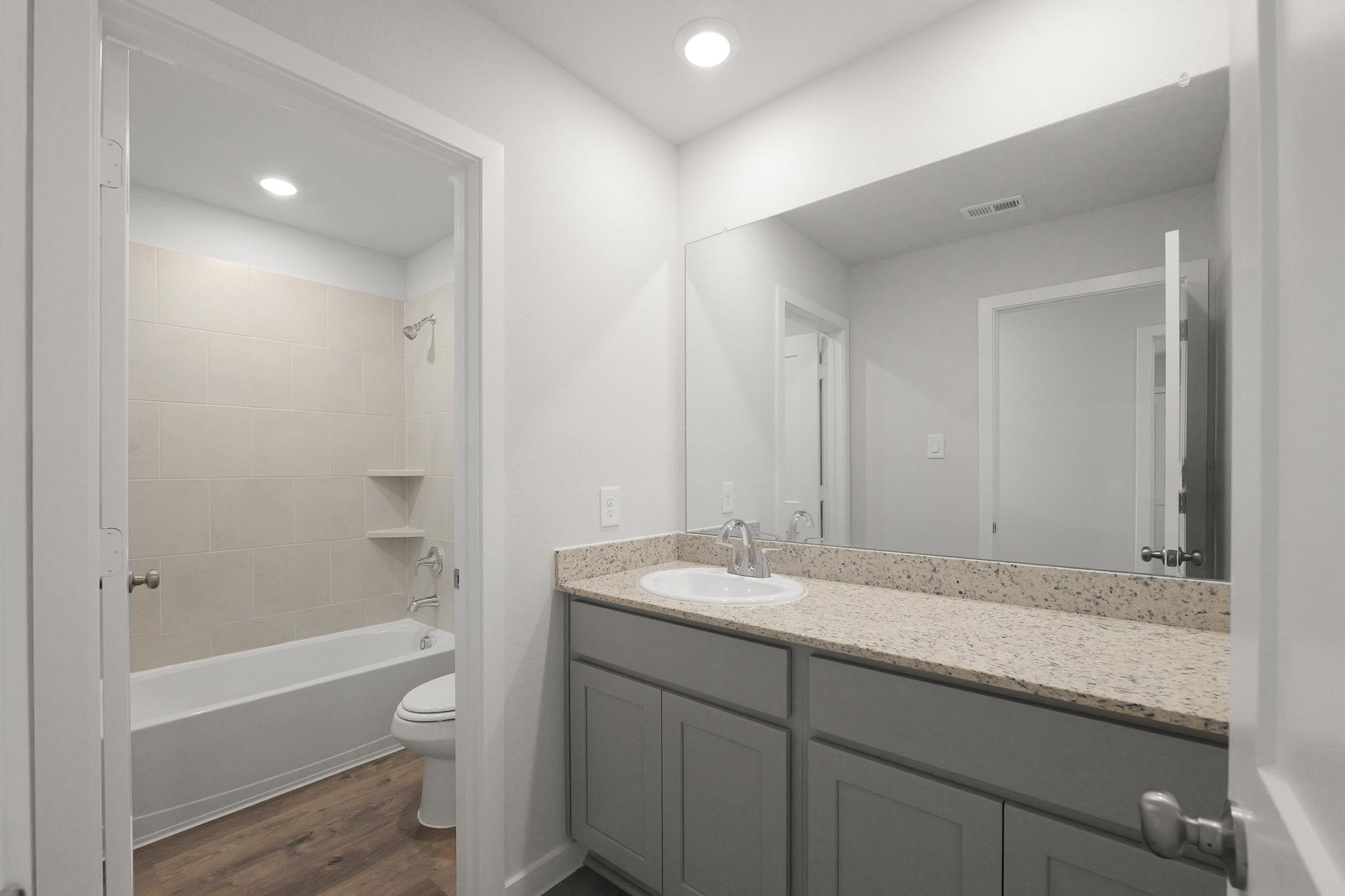 A bathroom with a marble countertop.