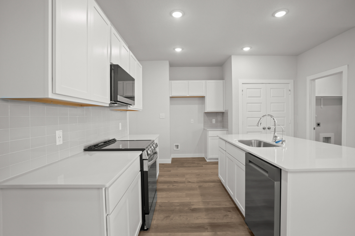 A kitchen with white cabinets.