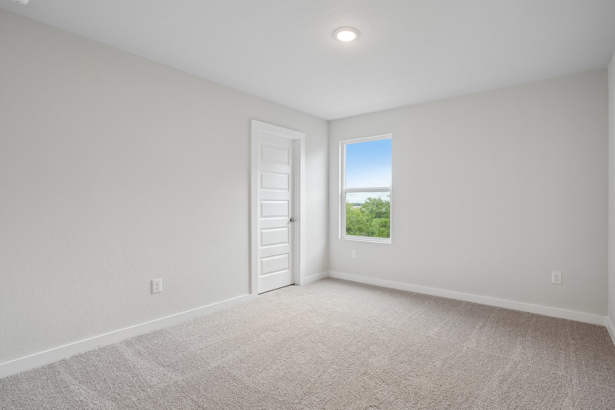 A room with a window and a door.
