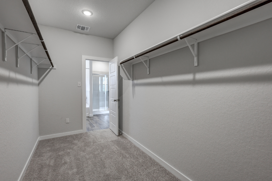 A hallway with a door and a window.