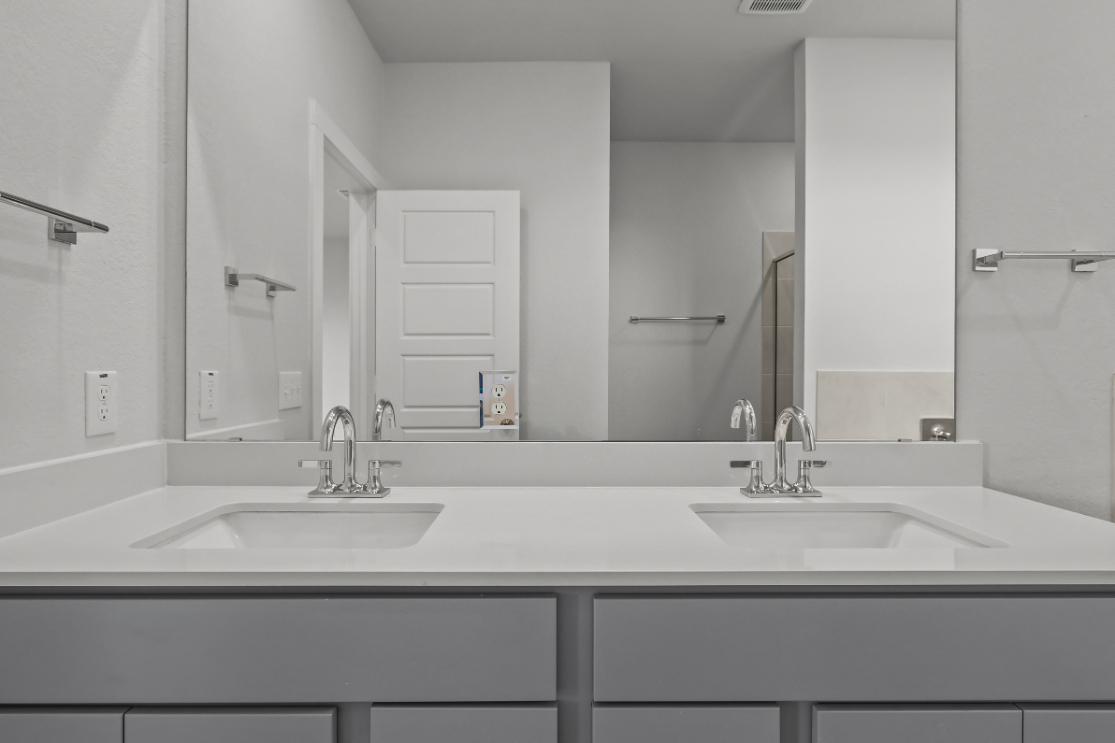 A bathroom with a large mirror.