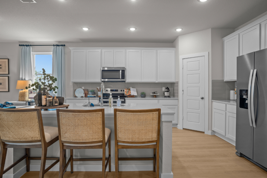 A kitchen with white cabinets.