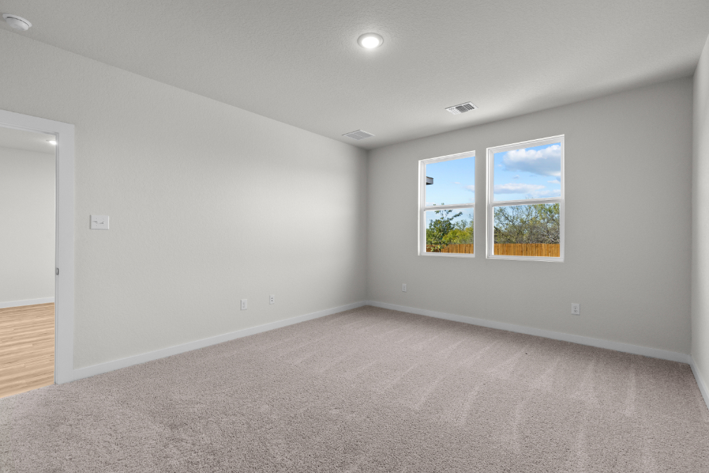 A room with a window and a carpet.