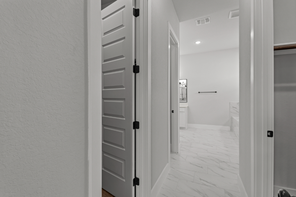 A hallway with white doors.
