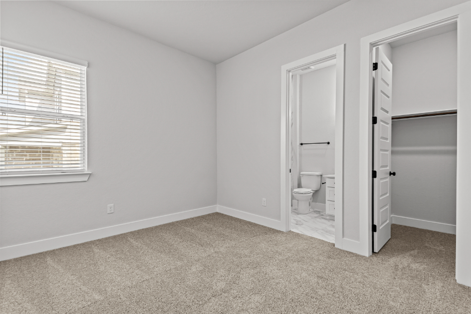 A bathroom with a toilet and a sink.