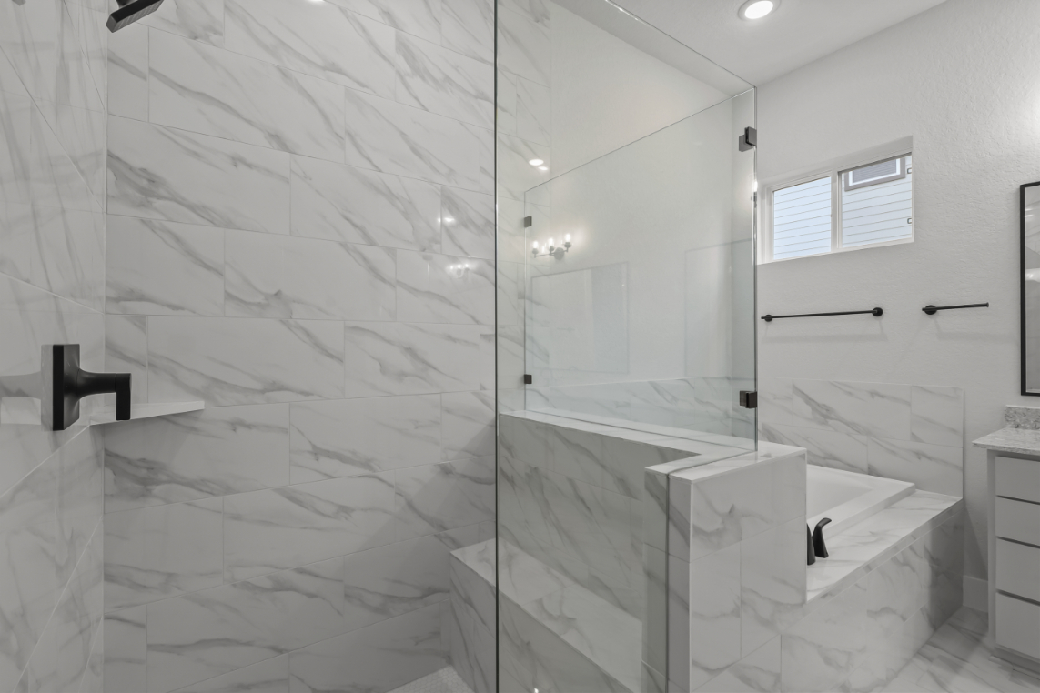 A bathroom with a shower and sink.