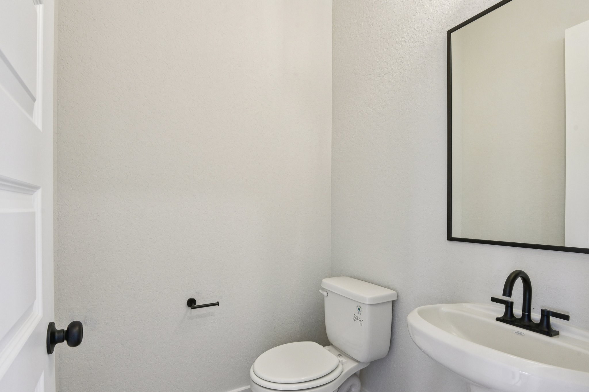 A bathroom with a toilet and sink.