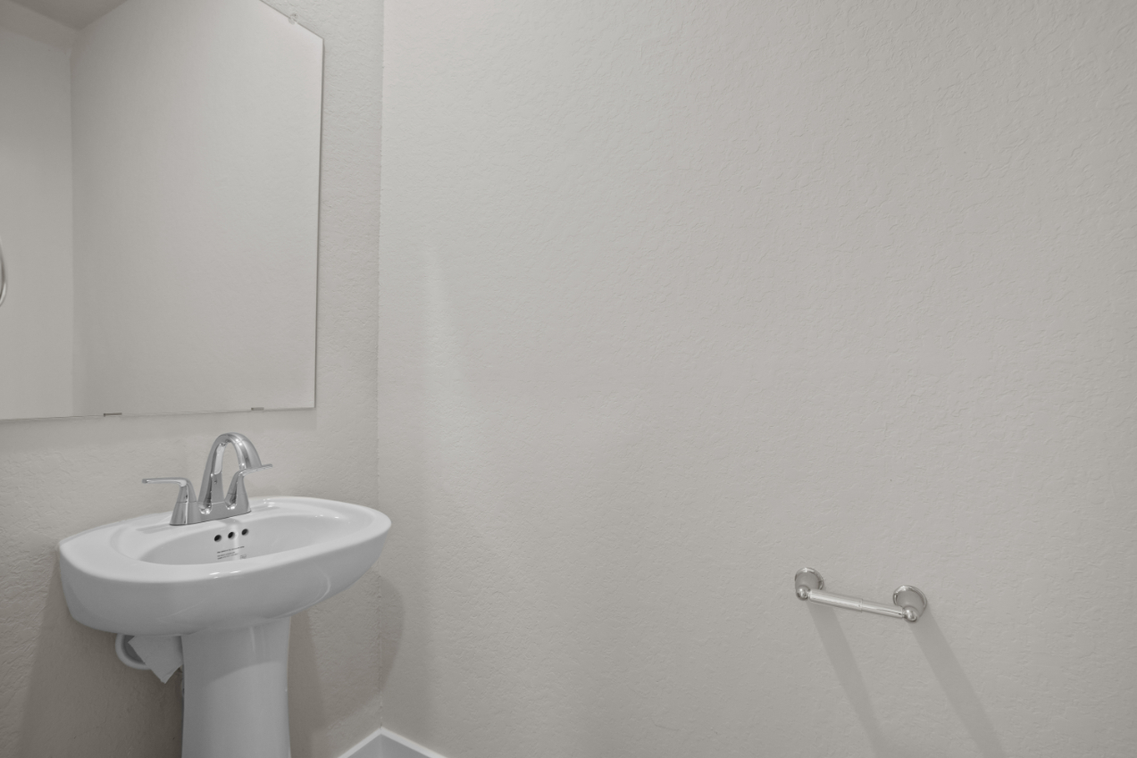 A bathroom with a sink and mirror.