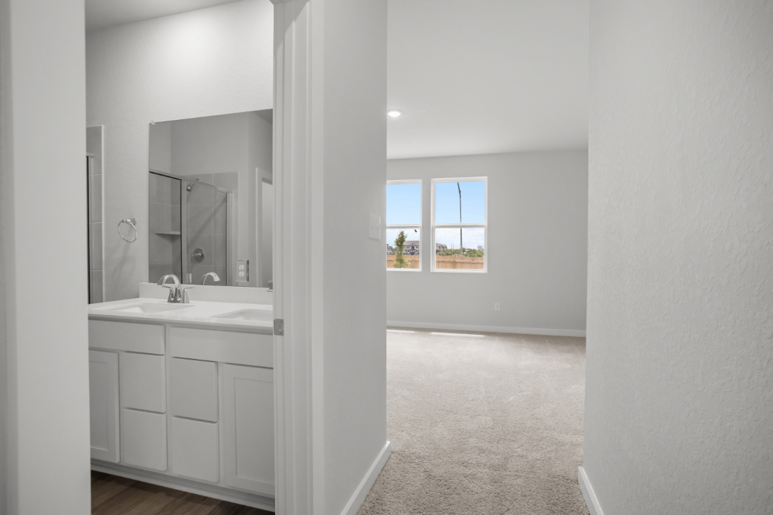 A bathroom with a large mirror.