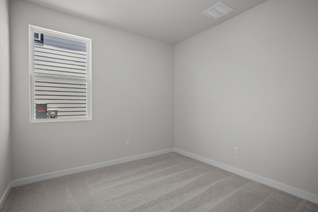 A room with a vent and a window.