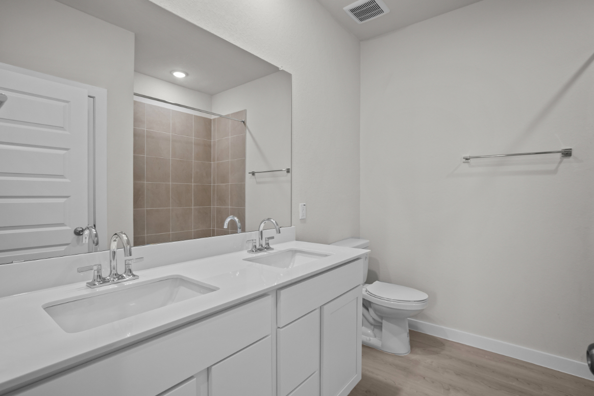 A bathroom with a large mirror.