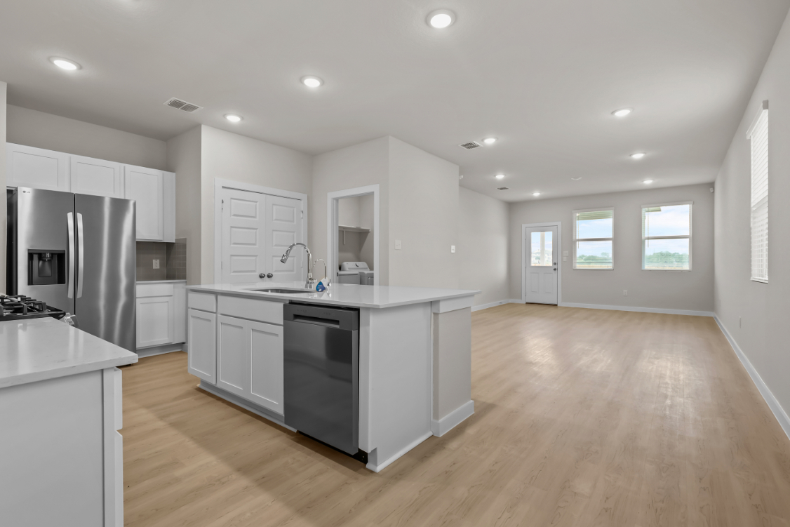 A kitchen with white cabinets.