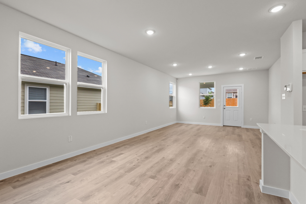 A room with white walls and a wood floor.