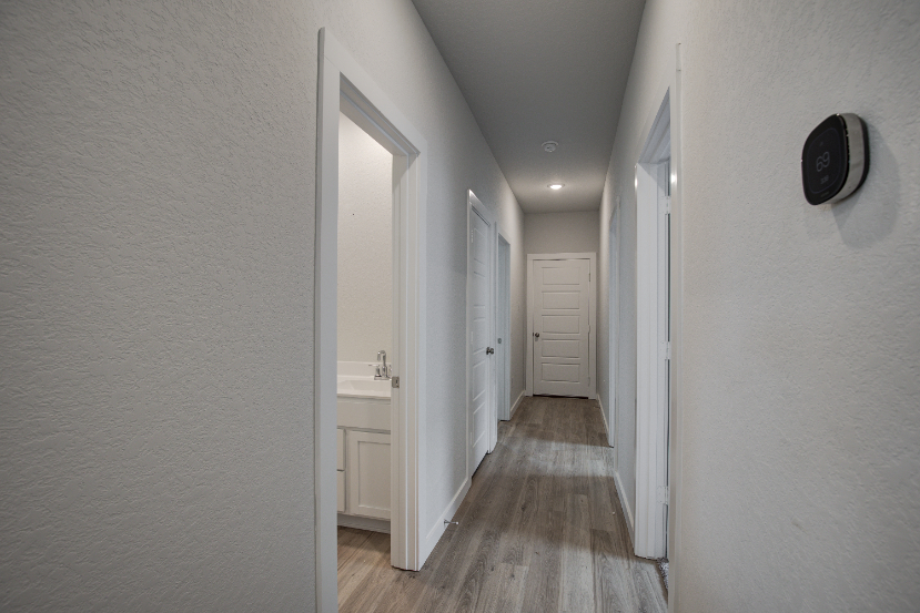A hallway with white doors.