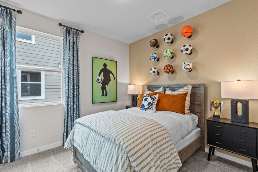 A bedroom with a bed and a lamp.