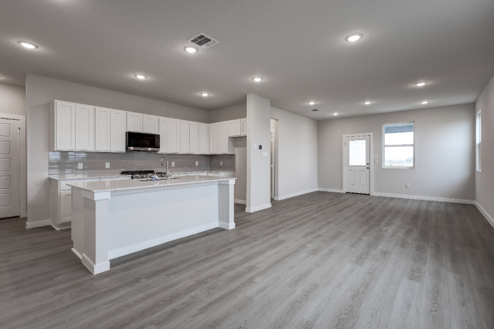 A kitchen with white cabinets.