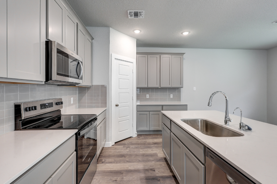 A kitchen with white cabinets.