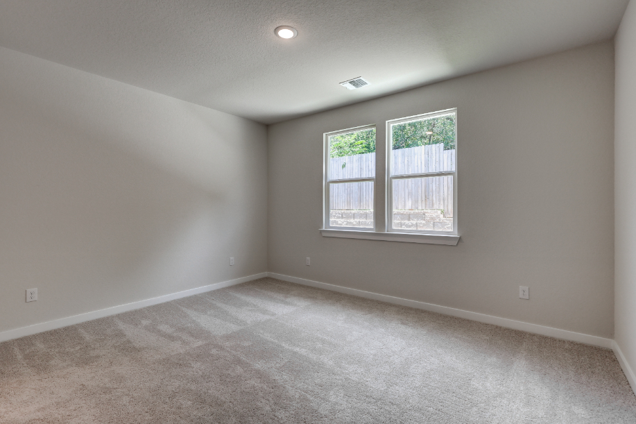 A room with a window and a carpet.