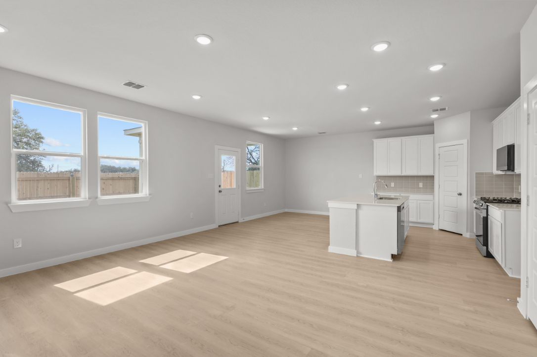 A large kitchen with white cabinets.