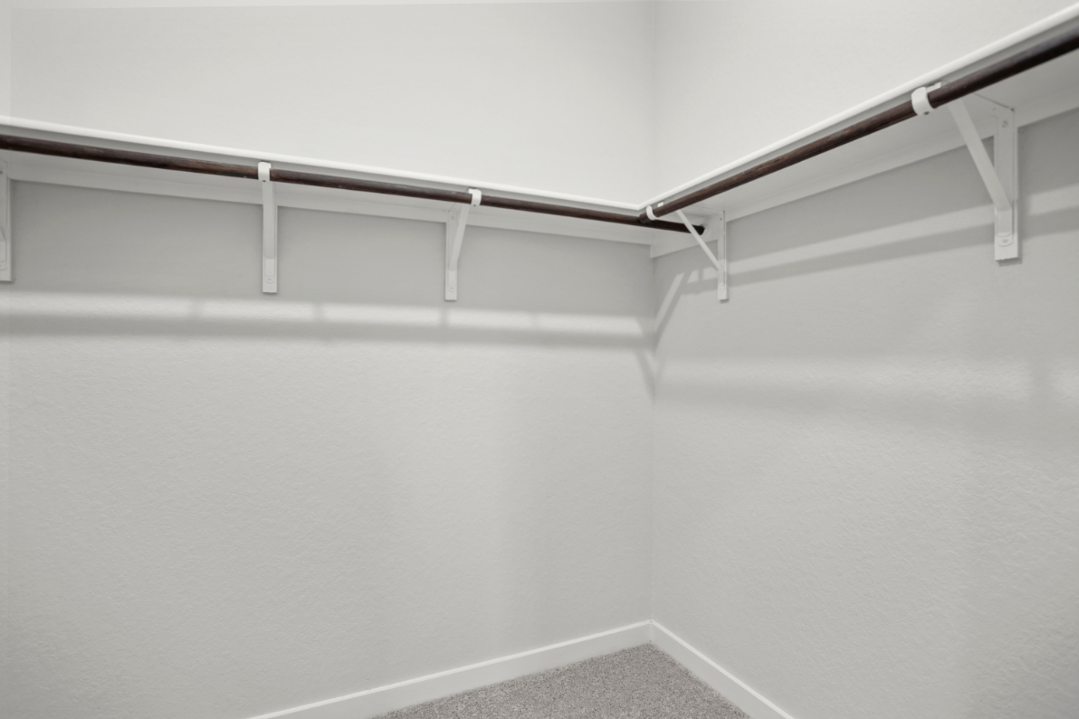A white wall with a metal railing.