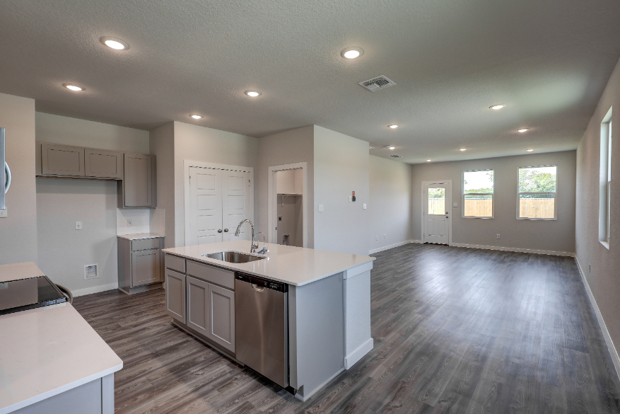 A kitchen with white cabinets.