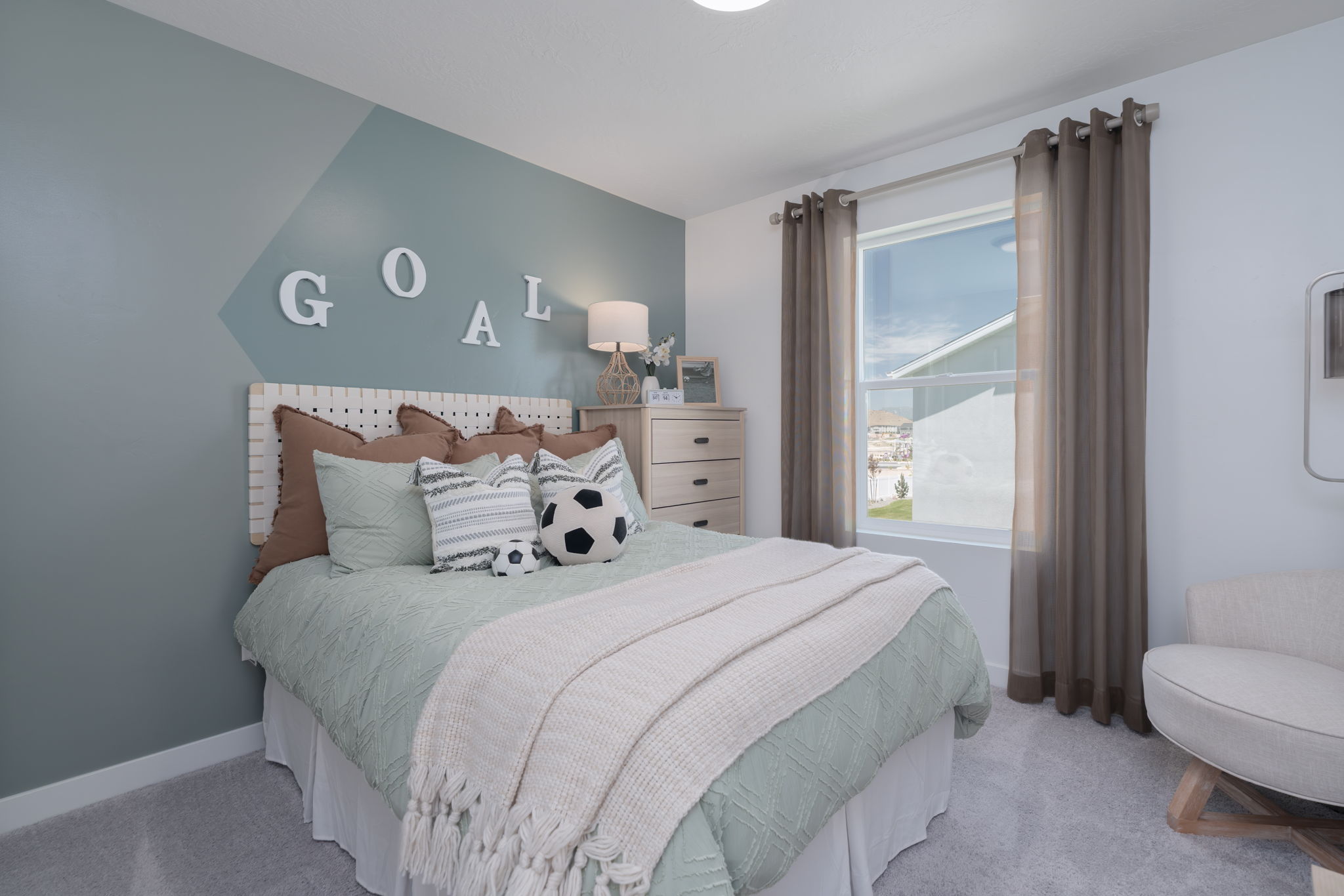 A bedroom with a large window.