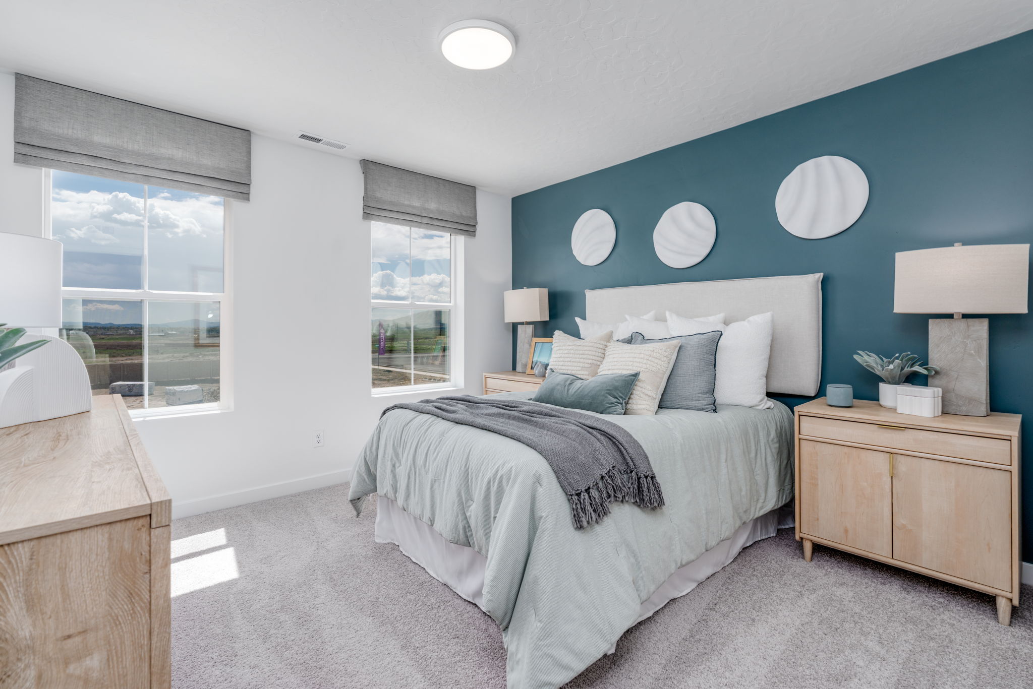 A bedroom with a bed and a window.