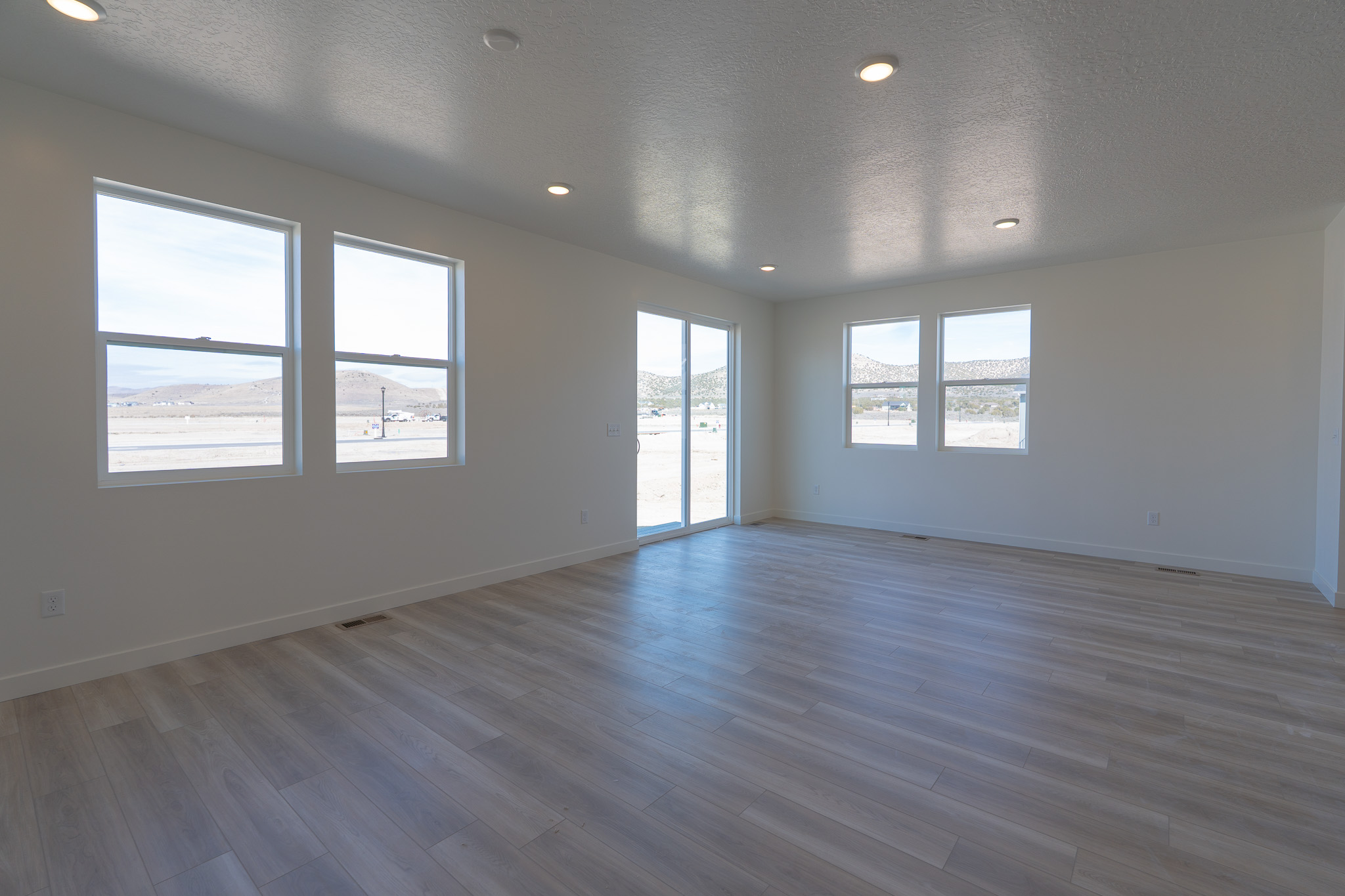 A room with windows and wood floors.
