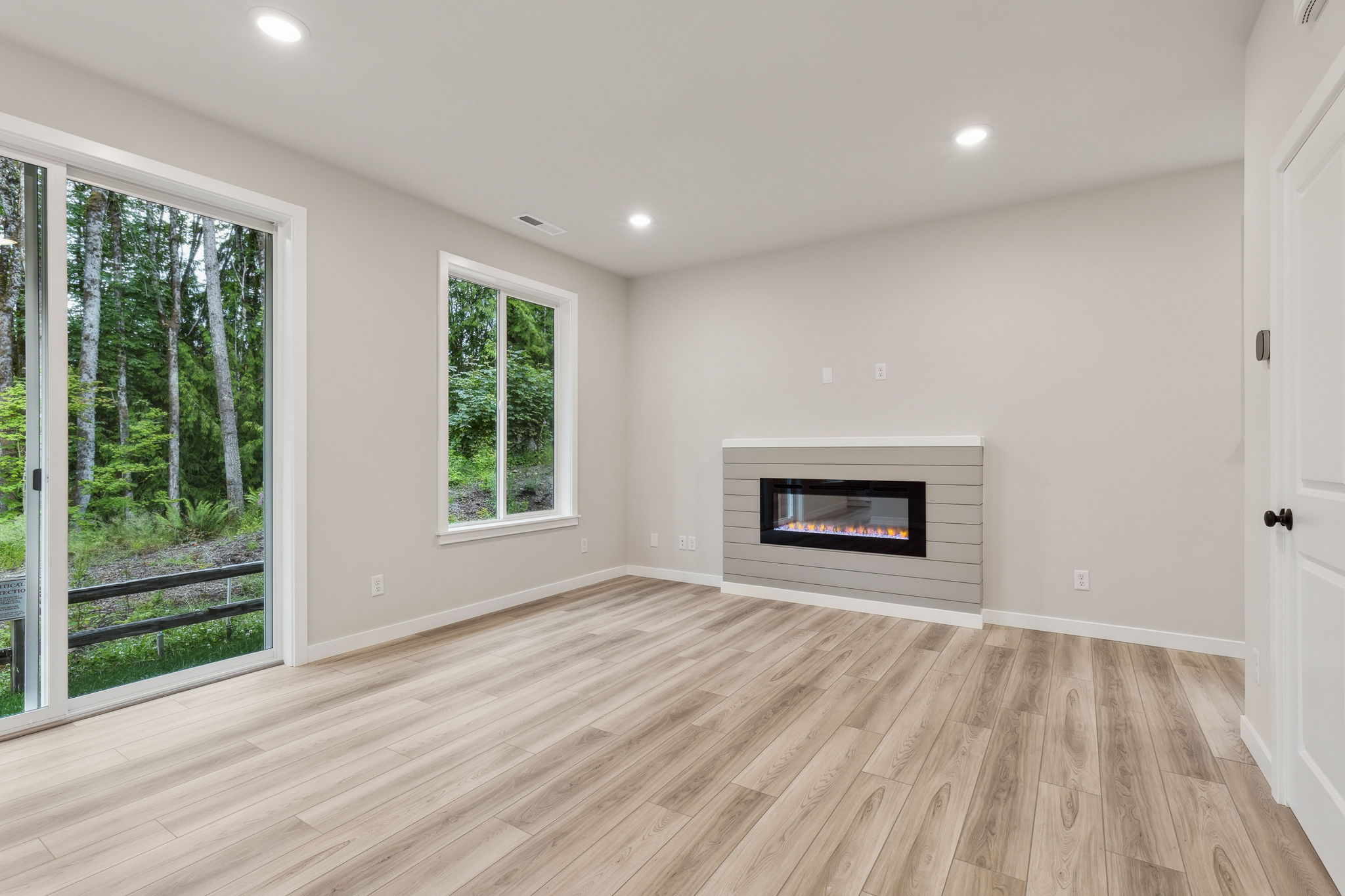 A room with a fireplace and windows.