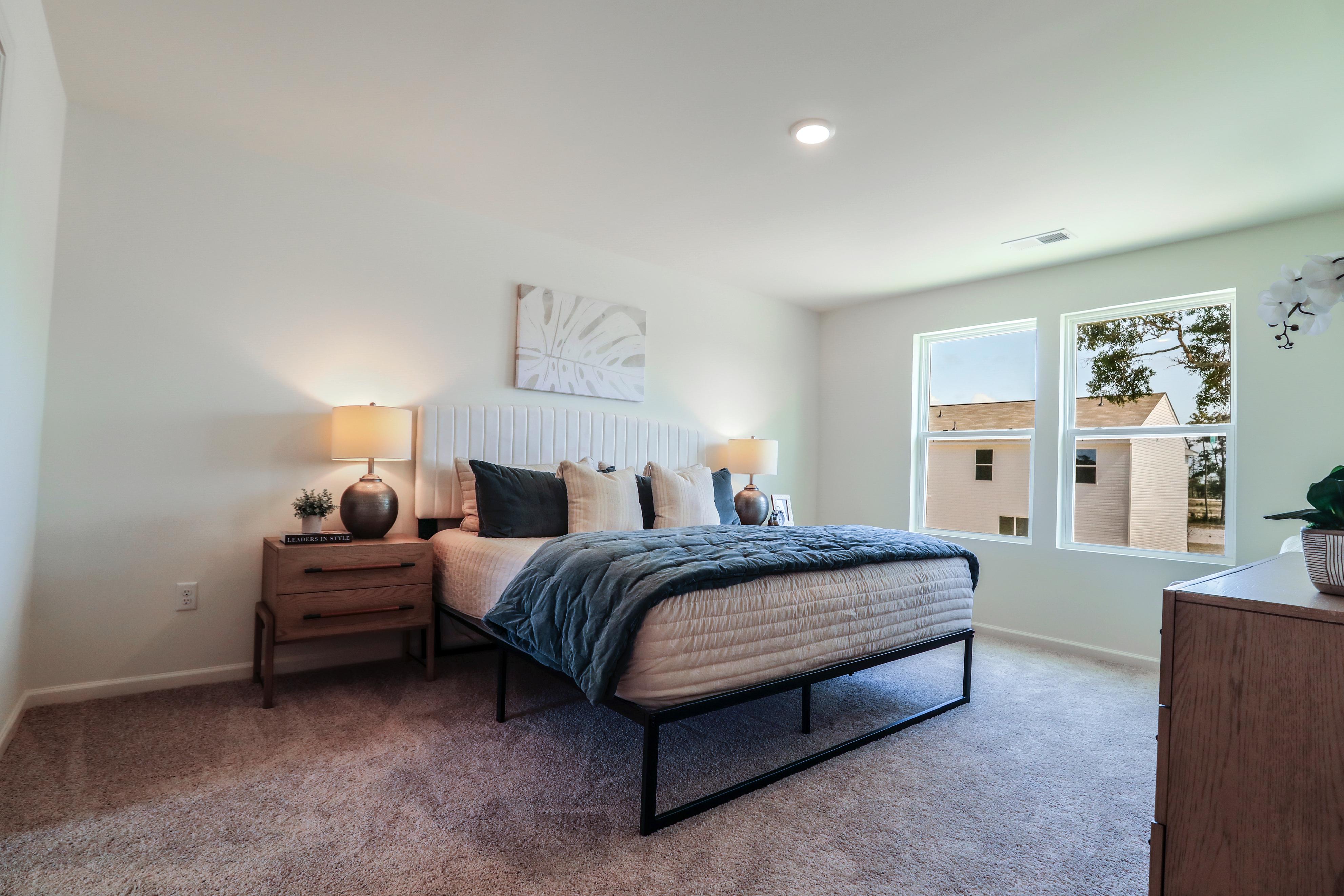 A bedroom with a bed and a window.