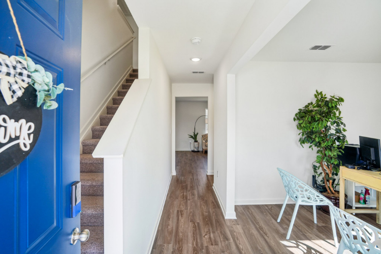 A room with a wood floor and white walls.