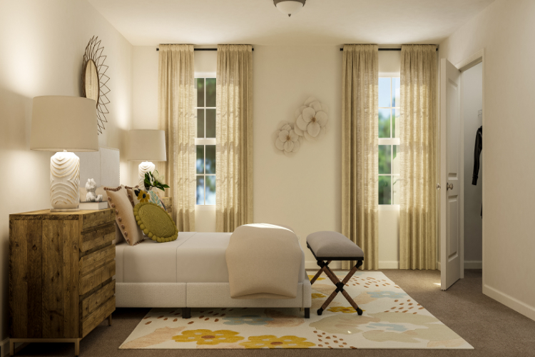 A living room with a white couch and a white chair.
