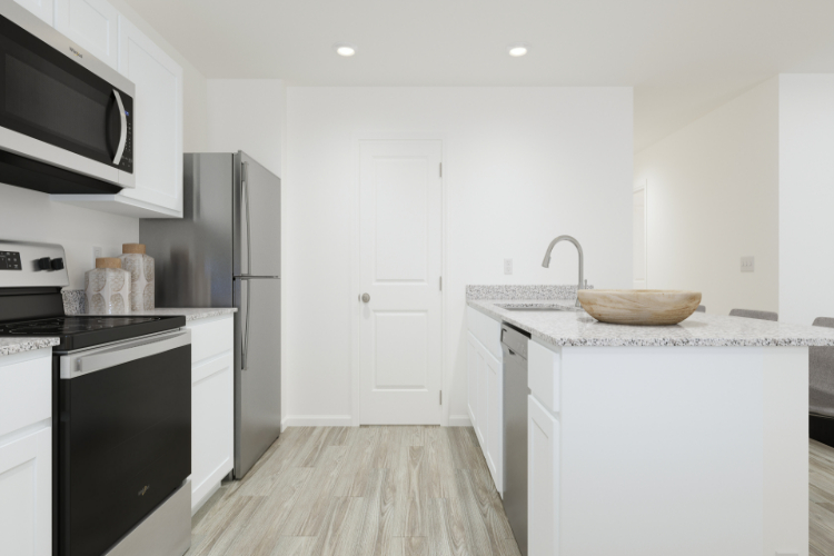 A kitchen with white cabinets.