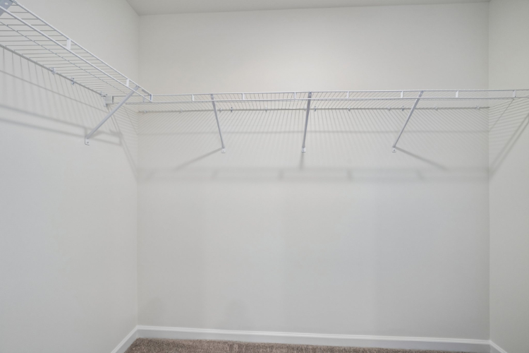 A white wall with a metal railing.