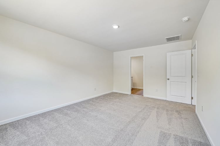 A hallway with white doors.
