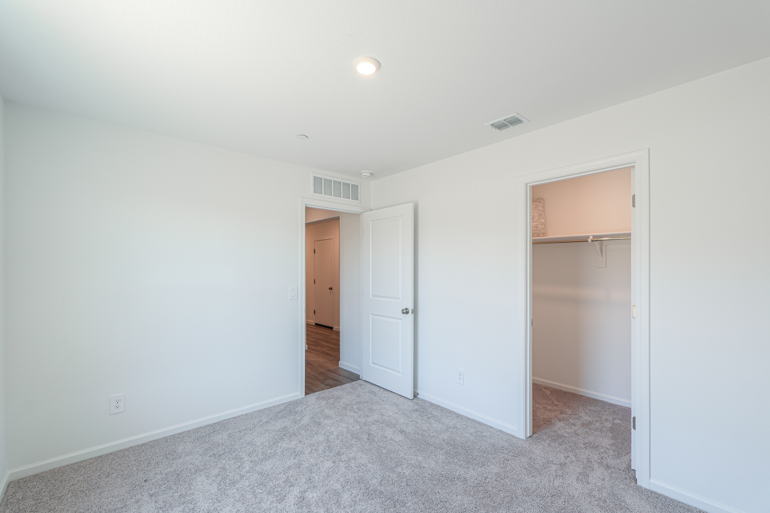 A hallway with white doors.