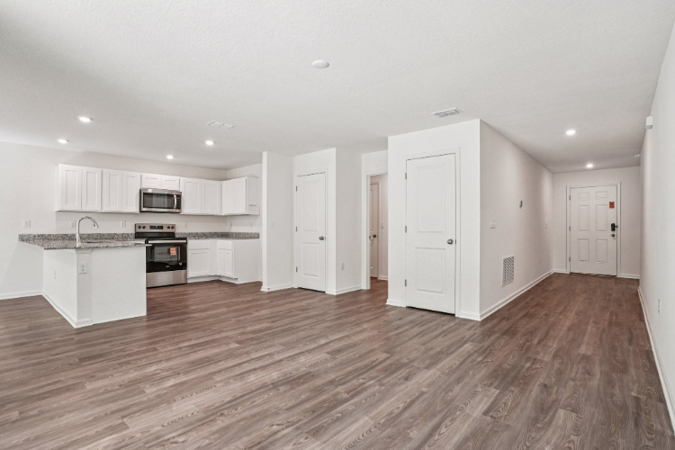 A large kitchen with white cabinets.