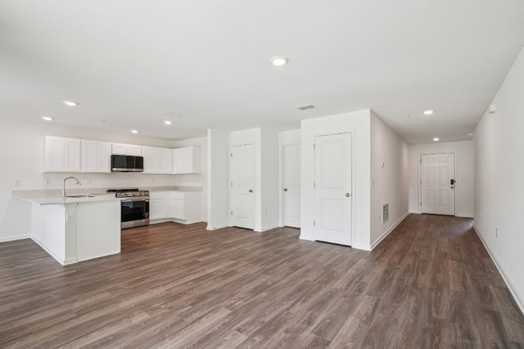 A large kitchen with white cabinets.
