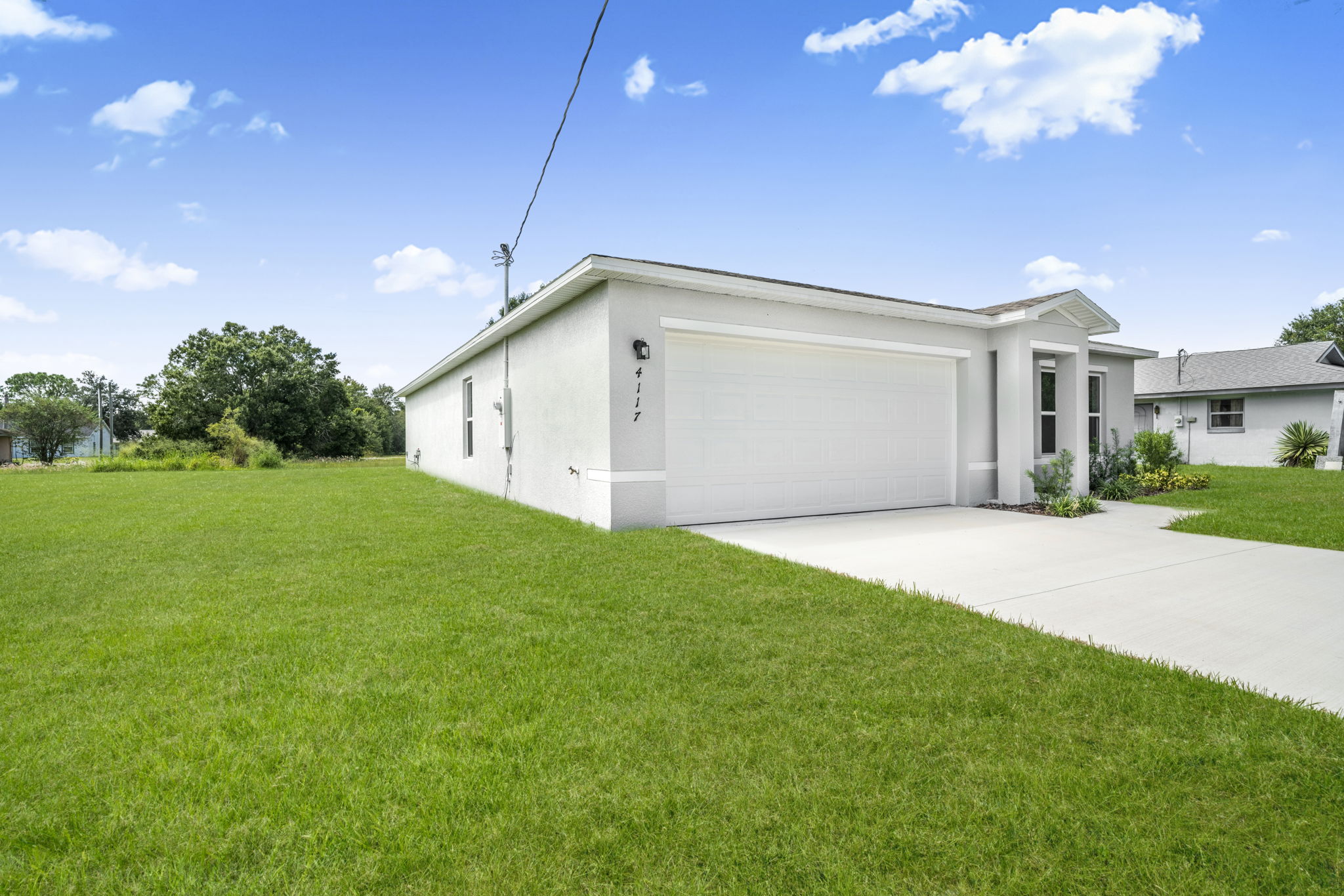 A white house with a garage.