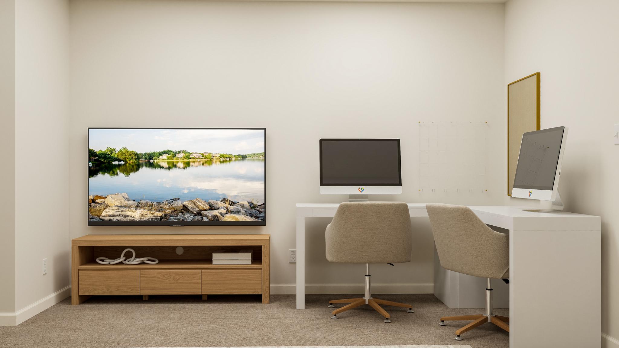 A room with a desk and a tv.