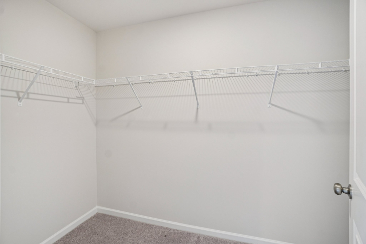 A white wall with a metal bar.