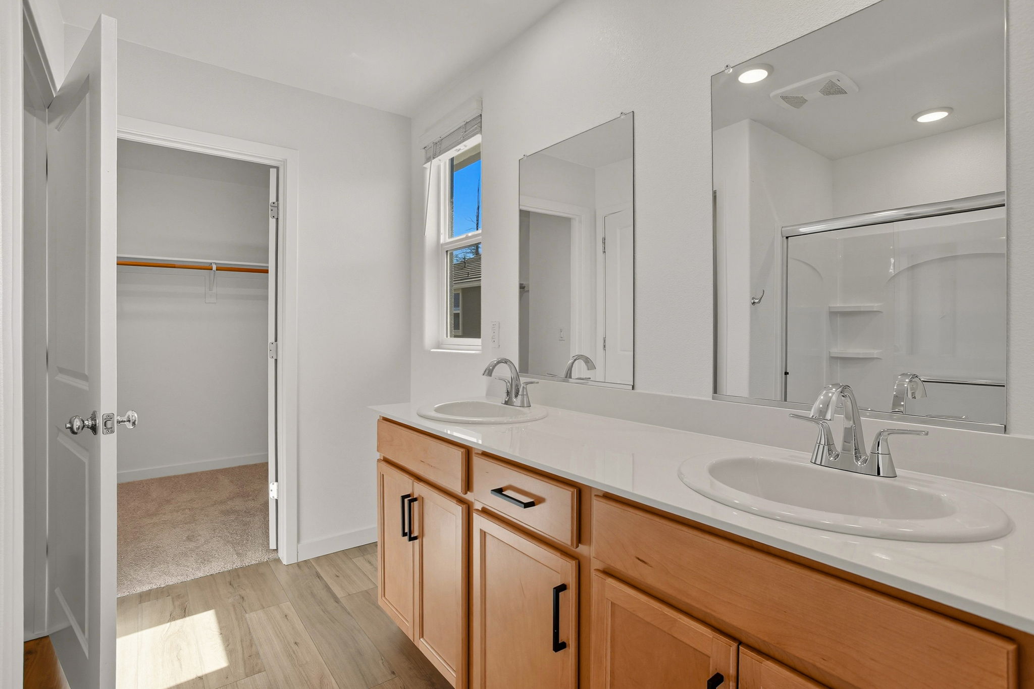 A bathroom with a large mirror.