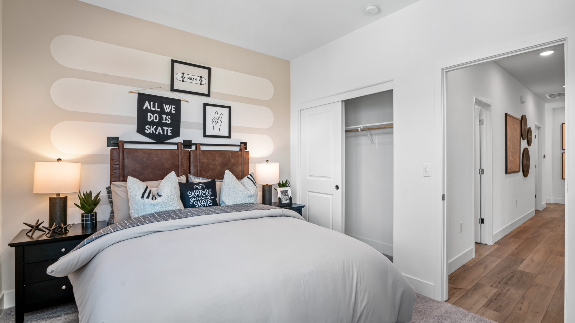 A bedroom with a bed and lamps.